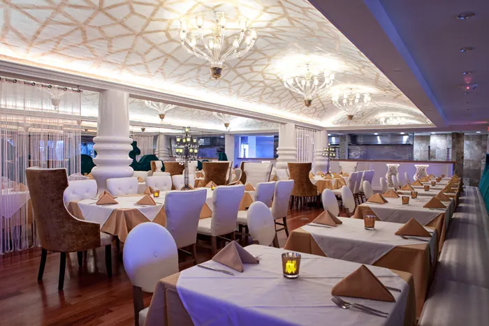 Restaurant Build Out Sand Lake Rd, Orlando: dining room with chandeliers and white-cloth tables.