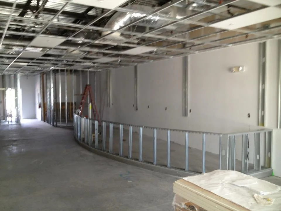 A vanilla shell in progress in Orlando: open ceiling and curved metal stud framing.