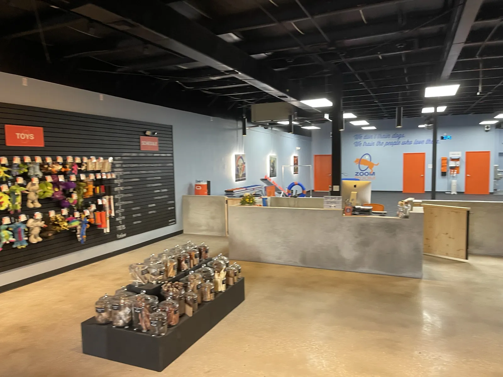 Zoom Room Longwood FL: reception and retail area with an exposed black ceiling.